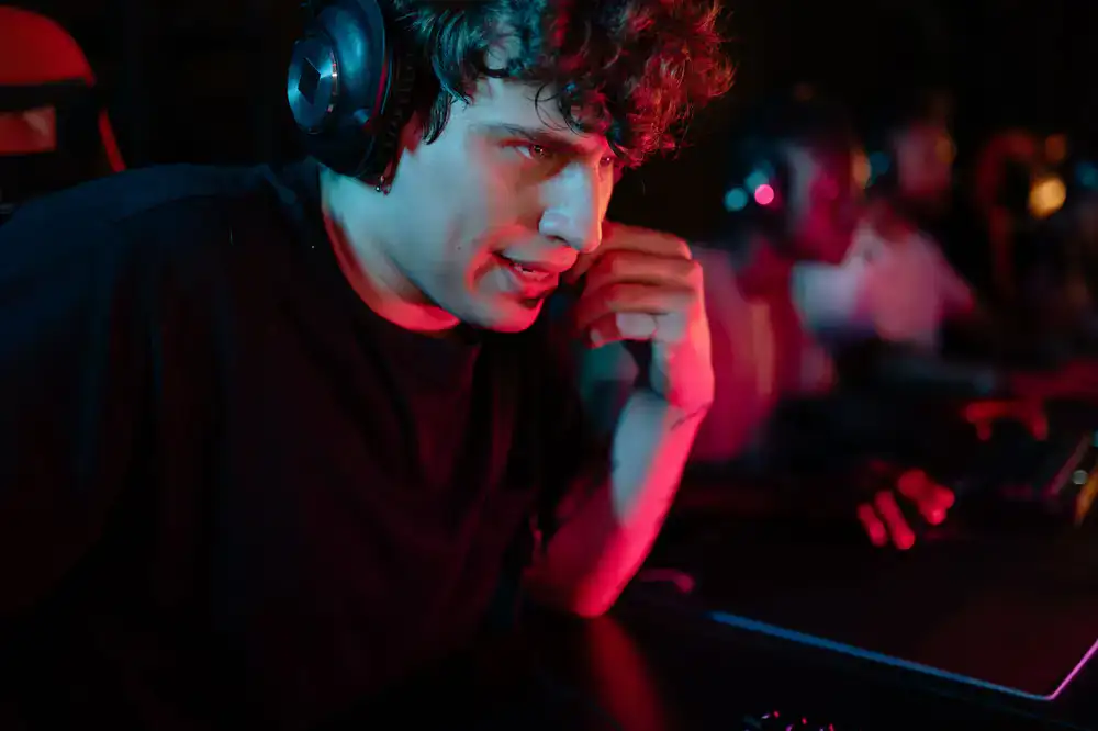 Amateur esports team communicating with headsets during an intense match